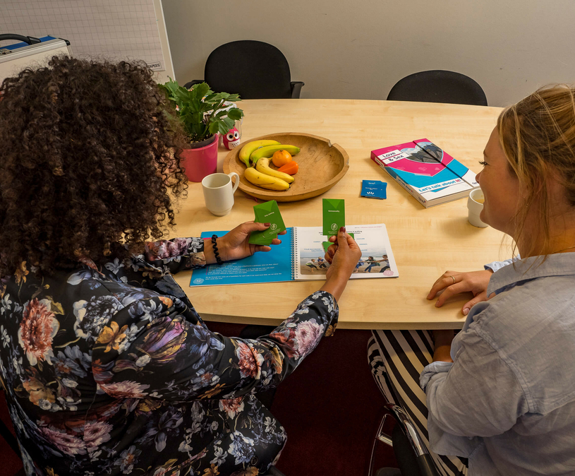 twee mensen aan tafel die een spel spelen