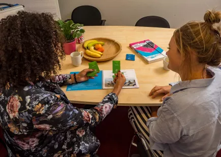 twee mensen aan tafel die een spel spelen